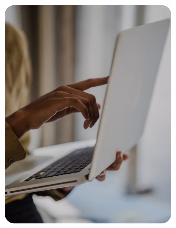 Close-up of a person using a laptop computer.